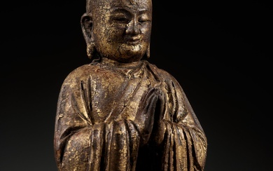 A GILT-LACQUERED WOOD FIGURE OF ANANDA, YUAN TO MING DYNASTY