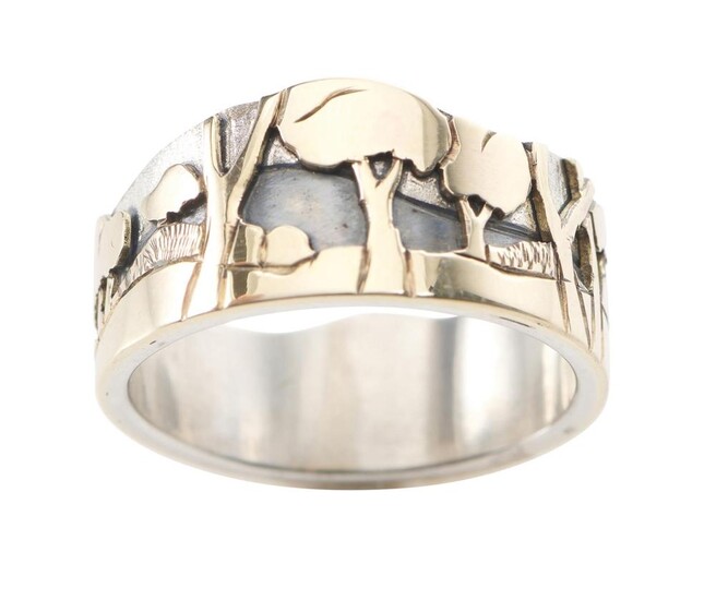 A GOLD AND SILVER RING BY TONY KEAN The wide band with an undulating landscape scene in relief, signed, in 9ct gold and sterling sil...
