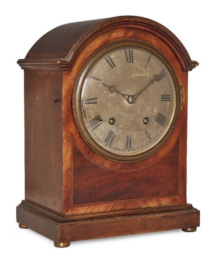 A German mahogany mantel clock, circa 1920, the case with arched moulded cornice, the brass dial with Roman numerals, the twin train movement by Winterhalder & Hofmeier, chiming a gong on the quarter hour, with pendulum, 31.8cm high, 23.3cm wide...