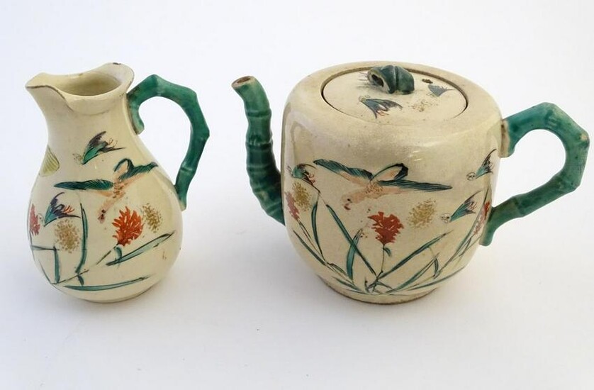 A Japanese teapot and milk jug with hand painted