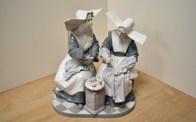 A Large Lladro porcelain figure group 'Nun's Sewing Circle' number 5360, formed as two seated nuns