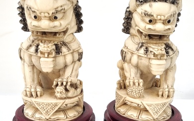 A PAIR OF CHINESE CARVED IVORY TEMPLE FOO DOGS