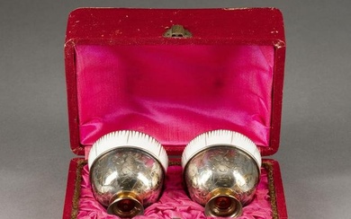 A PAIR OF PORCELAIN CUPS WITH SILVER FOOT WITHIN CASE Ru
