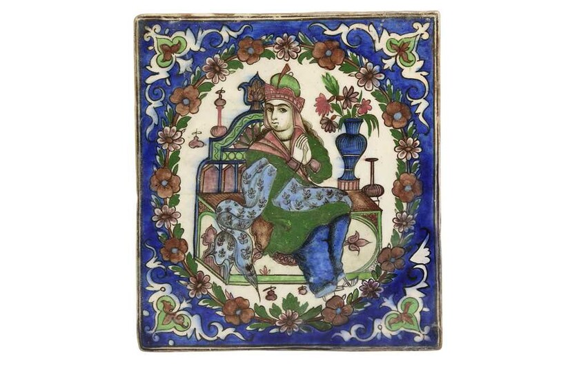 A POTTERY TILE DEPICTING A SEATED PRINCE Late Qajar or Early Pahlavi Iran, early 20th century