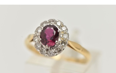 A RUBY AND DIAMOND CLUSTER RING, a principally set oval cut ...