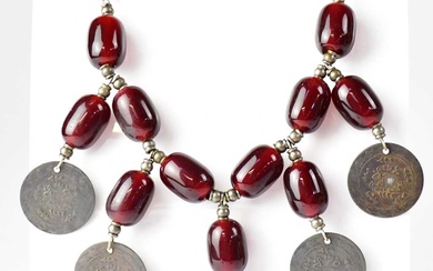 A Turkish cherry amber coloured bead necklace set with five...
