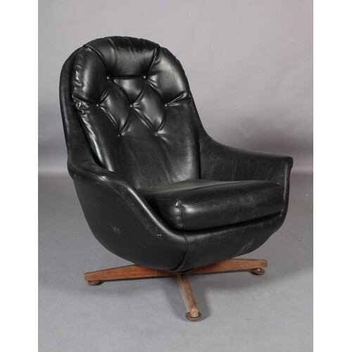 A black buttoned leatherette swivel armchair on a wooden fou...