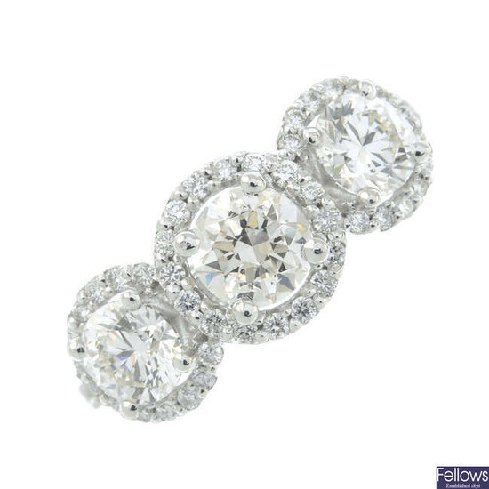 A brilliant-cut diamond triple cluster ring.