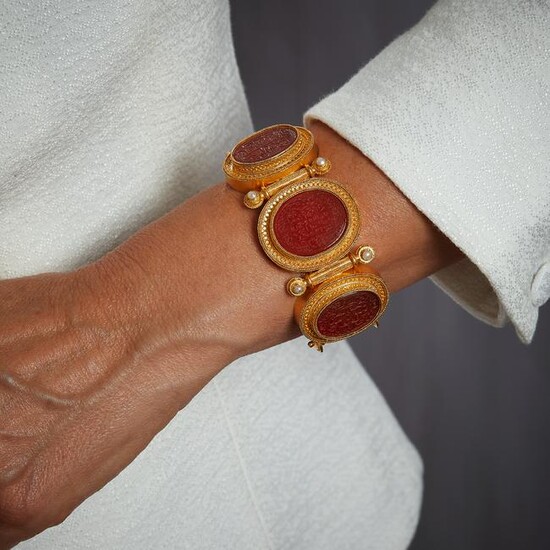 A cornelian intaglios and gold bangle attributed to
