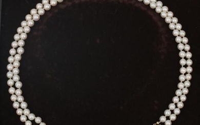 A cultured Akoya pearl necklace to a rose cut diamond clasp. Composed of a double strand of cultured Akoya pearls to a 14 karat gold and silver rose cut diamond clasp. Gross weight: 50 g.