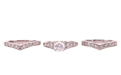 A diamond solitaire ring and two diamond-set half-hoop etern...