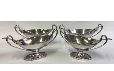 A find set of four George III silver twin-handled salts with...