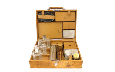 A gentleman's leather travelling toilet case by Cartier