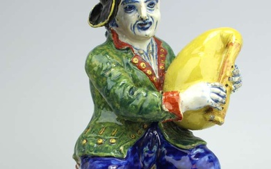 A large Delft polychrome pottery figure of a bagpipe player