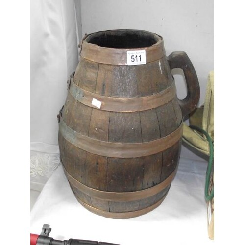 A large copper and wood barrel / jug