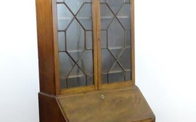A late 18thC mahogany Georgian bureau bookcase with a