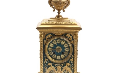 A late 19th century bronze mantle clock, cast with rocailles, vase and foliage, sides and front decorated with grotesques and foliage. H. 41 cm.