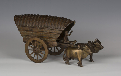A late 19th century brown patinated bronze model of an ox-drawn carriage, bearing stamped signature
