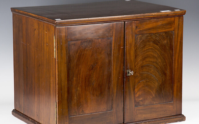 A late 19th century figured mahogany table-top collector's cabinet, the two panelled doors encl