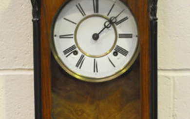 A late 19th century walnut and ebonized Vienna style wall clock with eight day movement striking on