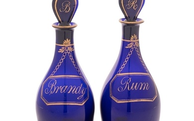 A pair of Bristol blue glass 'Rum' and 'Brandy' decanters an...