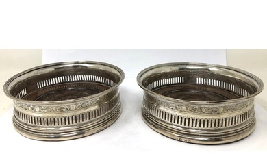 A pair of George III silver and mahogany bottle coasters, Ro...