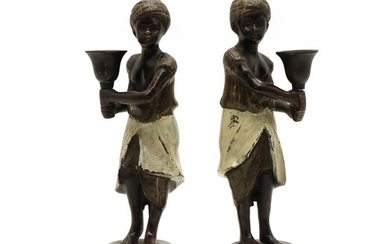 A pair of bronze gold painted candlesticks in the manner of Franz Bergman