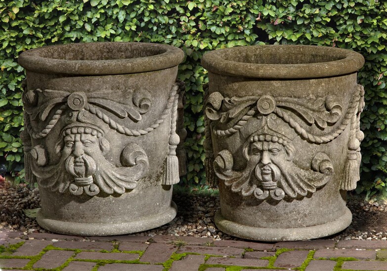 A pair of carved limestone planters