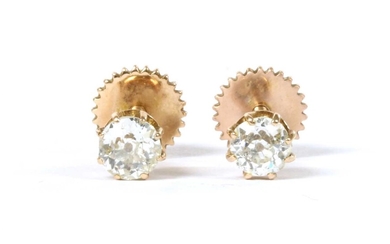 A pair of gold single stone diamond stud earrings