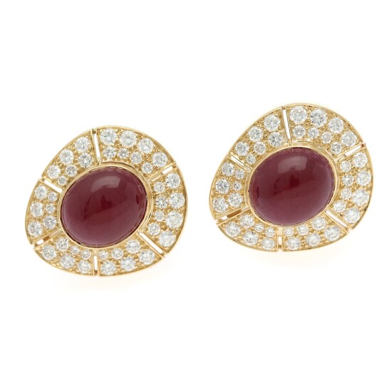 A pair of ruby and diamond ear clips each set with a ruby totalling app. 6 ct. encircled by numerous diamonds totalling app. 3.50 ct., mounted in 18k gold. (2)