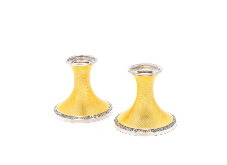 A pair of silver and enamel candlesticks