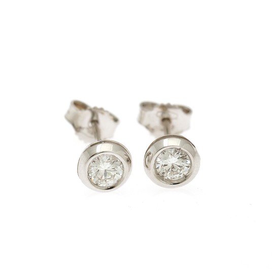 A pair of solitaire ear studs each set with a brilliant-cut diamond totalling app. 0.47 ct., mounted in 18k white gold. (2)