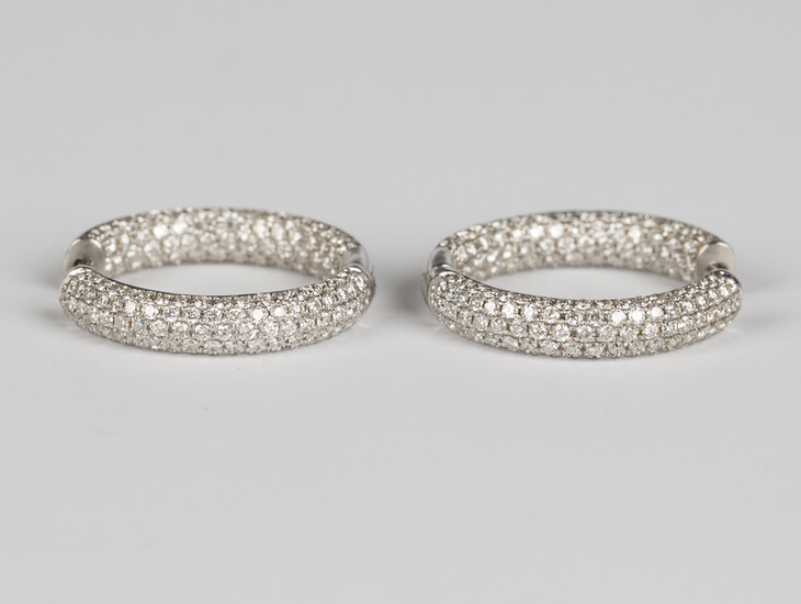 A pair of white gold and diamond hoop shaped hinged earrings, each pavÚ set with circular cut d