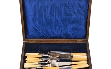 A part set of silver fruit eaters, Sheffield, c.1915, Walker & Hall, comprising three knives and four forks, together with a set of eight each silver plated Mappin & Webb fish eaters and an associated wooden box (a lot)