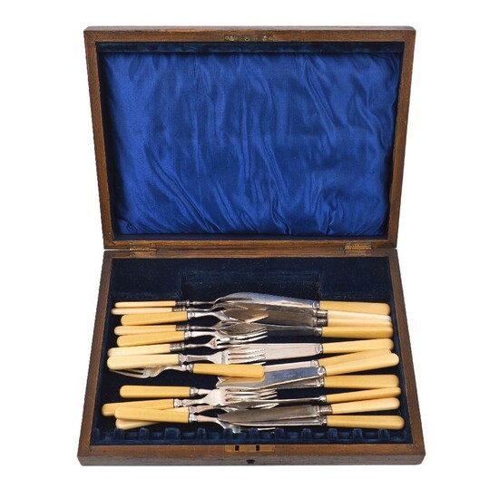 A part set of silver fruit eaters, Sheffield, c.1915, Walker & Hall, comprising three knives and four forks, together with a set of eight each silver plated Mappin & Webb fish eaters and an associated wooden box (a lot)