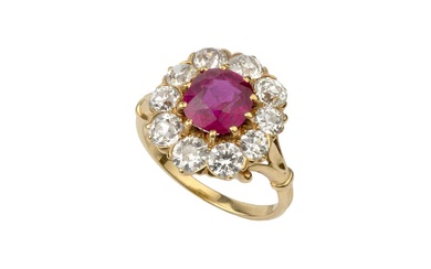 A ruby and diamond cluster ring, the central oval cut...