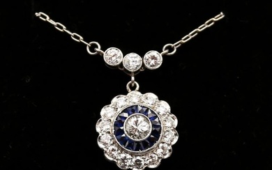 A sapphire and diamond platinum cluster pendant, comprising circular design...