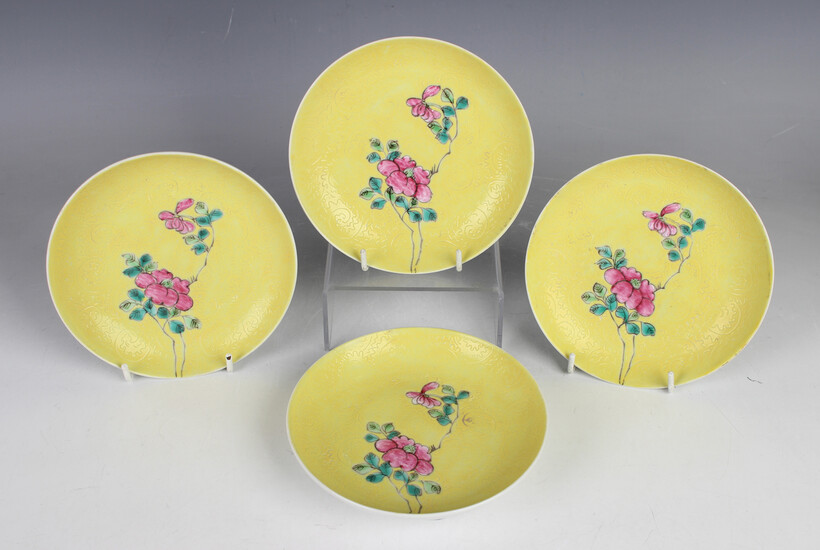 A set of four Chinese famille rose enamelled yellow ground porcelain saucer dishes, mark of Tongzhi