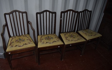 A set of four (three plus one) early 20th Century mahogany dining chairs having applique design rail