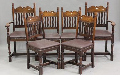 A set of six mid-20th century Arts and Crafts style oak dining chairs with shaped bar and wavy spind