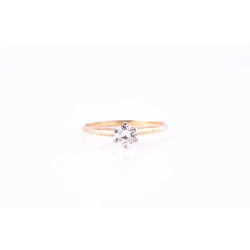A single-stone diamond ring, the round brilliant cut to a si...