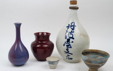 A small collection of Asian pottery, to include: a Japanese baluster shaped flask with wooden stopper, decorated to the body with blue calligraphy, 36.5cm high; a Chinese monochrome purple aubergine baluster vase with everted rim, unmarked, 24cm...