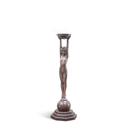 AN ART DECO-STYLE PATINATED METAL FIGURAL TABLE LAMP, in the...
