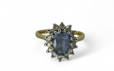 An 18ct gold diamond and pale blue sapphire cluster ring....
