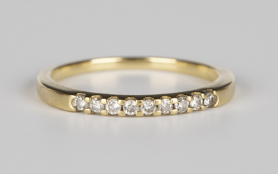 An 18ct gold ring, mounted with a row of nine circular cut diamonds, ring size approx N1/2.