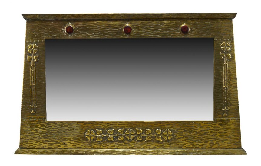 An Arts and Crafts brass framed over-mantel mirror with ceramic...