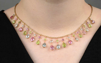 An Edwardian 15ct gold pink tourmaline, peridot and aquamarine harlequin fringe necklace.