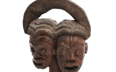 An Ekoi leather wrapped wooden twin mask with wicker collar/base and headdress....
