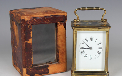 An early 20th century French lacquered brass cased carriage clock with eight day movement striking h