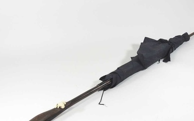An early 20th century Japanese parasol, the handle carved to...